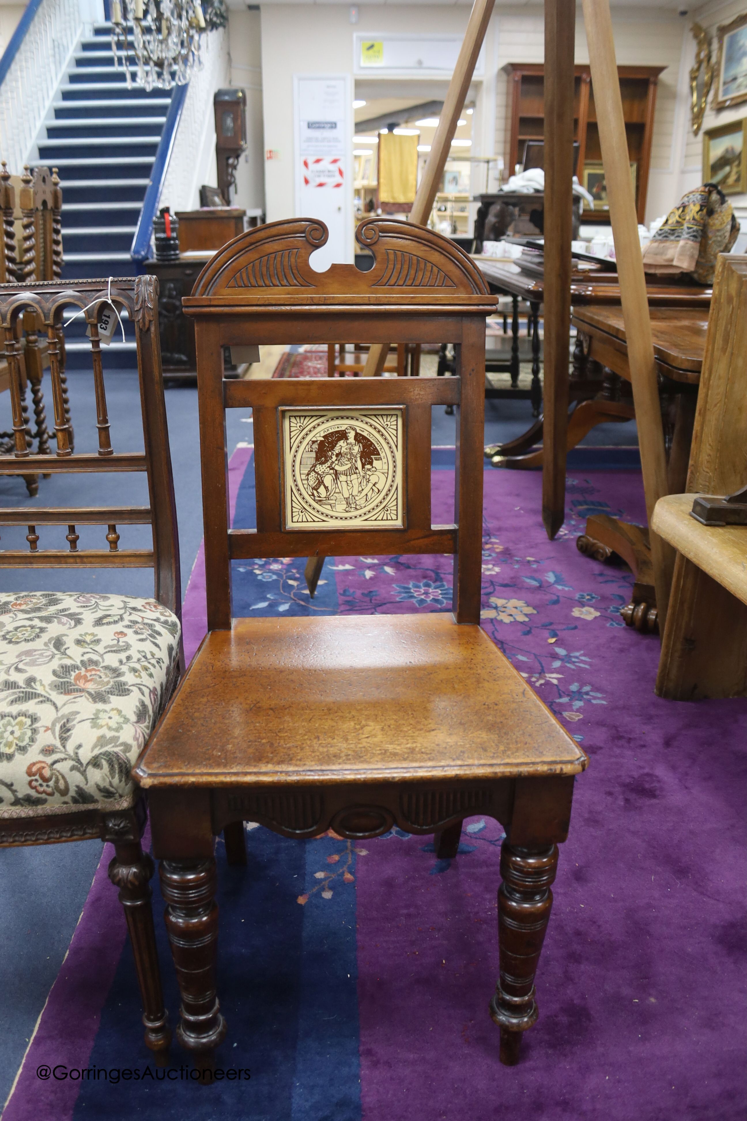 A late Victorian walnut hall chair with inset Minton tile and a Victorian walnut single chair.